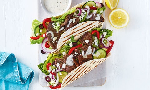Lamb Souvlaki Wraps on a plate with lemon wedges