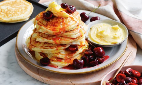 Buttermilk pancakes with honey butter and cherries