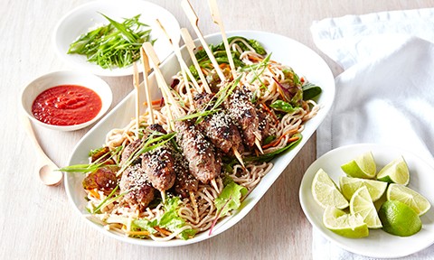 Asian-style beef kebabs on a noodle salad