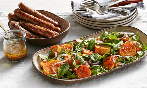 Curtis Stone’s Chargrilled sausages with sweet potato salad