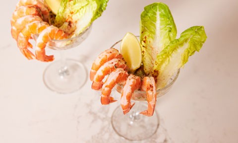 Two glasses of prawn cocktails with avocado and dill