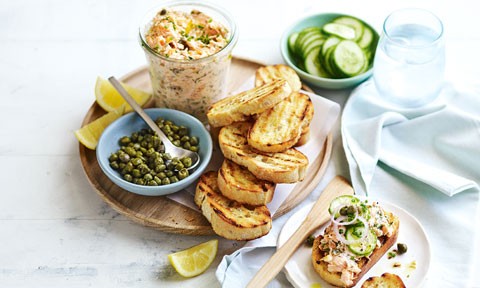 A stack of salmon rilletes served with lime and capers