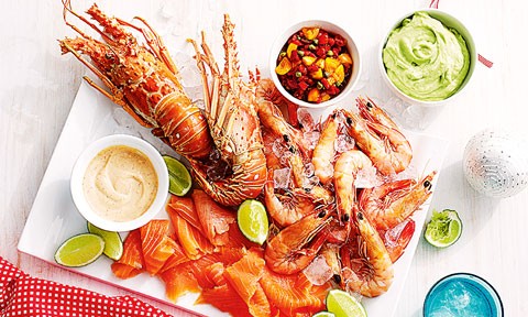 A platter of seafood with prawns, lobster, salmon and lime