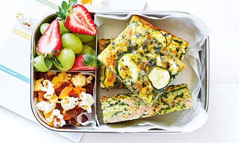 Tuna and zucchini slice in a lunchbox with fruit and granola