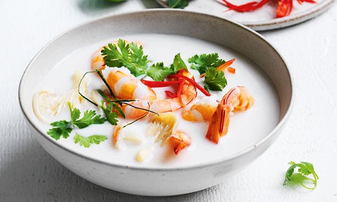 A bowl of Thai Coconut Soup with Prawns, garnished with flat leaf parsley