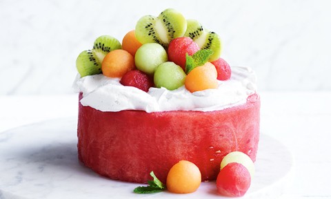 A watermelon cake topped with yoghurt and melon balls