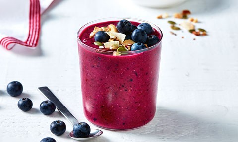 Dragon fruit smoothie topped with blueberries
