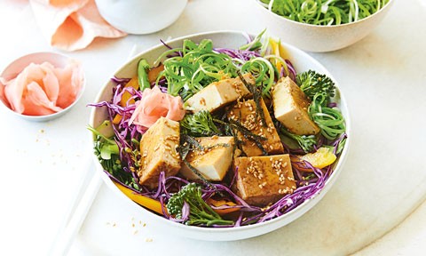 A bowl of japanese tofu salad served with pink ginger