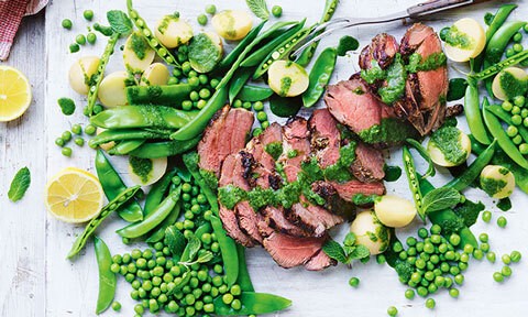 Thickly sliced BBQ lamb with pea salad and mint sauce