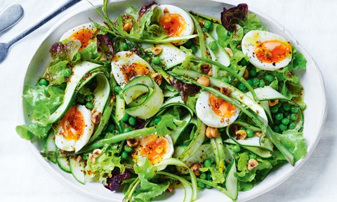 A bowl of zucchini and asparagus salad with egg