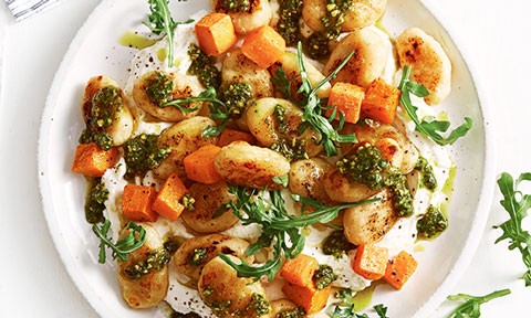 Gnocchi with pumkin and pesto served on top of whipped ricotta
