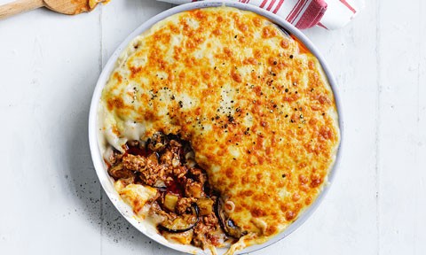 Cheesy lamb bake served in a baking dish with a spoonful removed