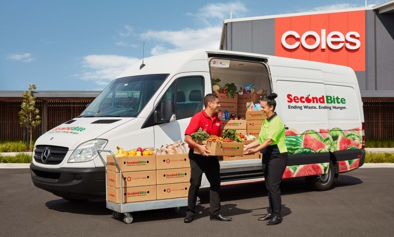 Secondbite van being loaded with fruit and vgetables by employees