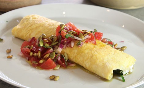 Omelette topped with tomato salad