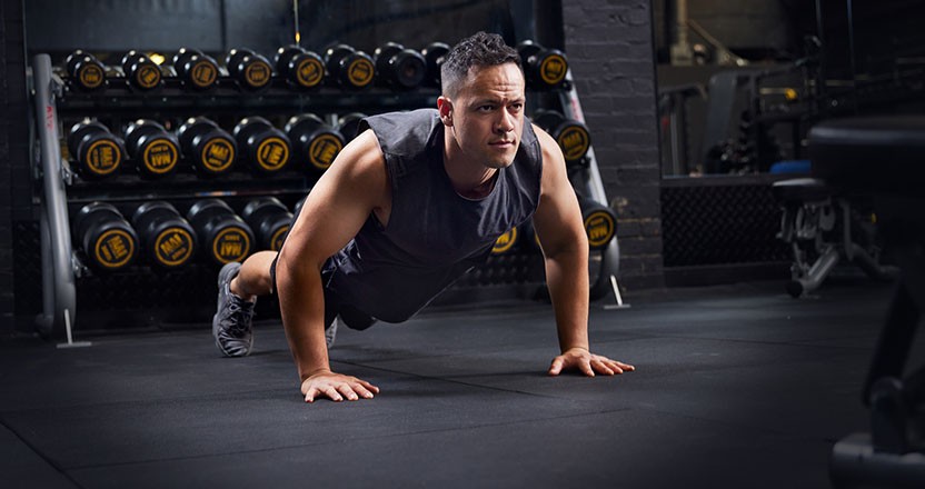 Man in a gym doing a pushup