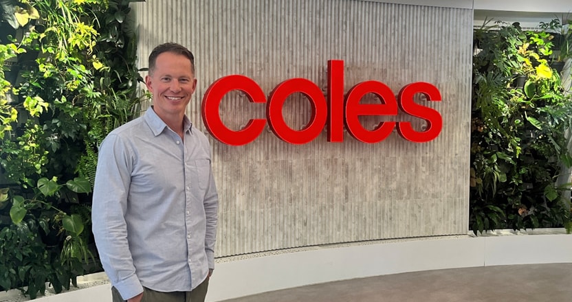 Ben Dixon standing in front of Coles sign
