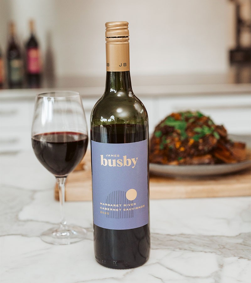 red wine bottle and glass with Middle Eastern Slow Cooked Lamb Shoulder