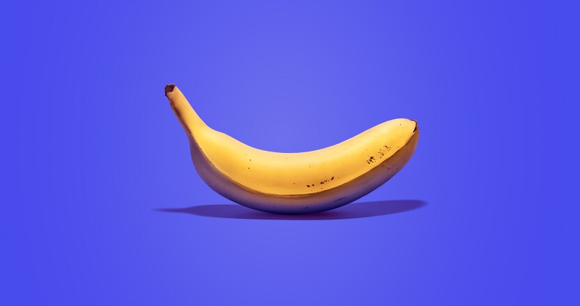 Banana in front of purple background