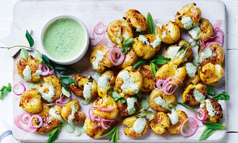 Smashed curried baby potatoes with green chilli yoghurt drizzled on top.
