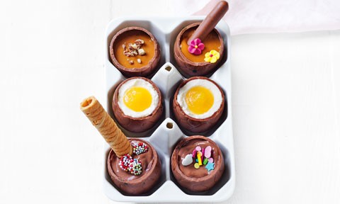 Six DIY filled Easter eggs topped with wafer rolls