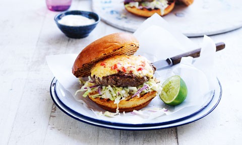 A Curtis Stone's southern-style cheeseburger and lemon wedges