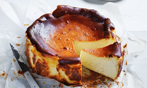A basque cheesecake with a slice cut out