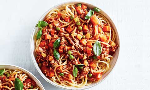 A bowl of spaghetti bolognaise with vegetable mixture