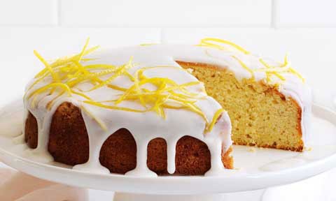 Lemon and cardamom drizzle cake cut in wedges