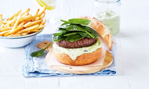 An open burger with spinach and fetta, served with fries
