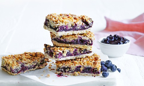 Stack of blueberry granola bars with blueberries jam