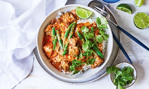 Red curry pork served on top of rice with green beans and coriander 