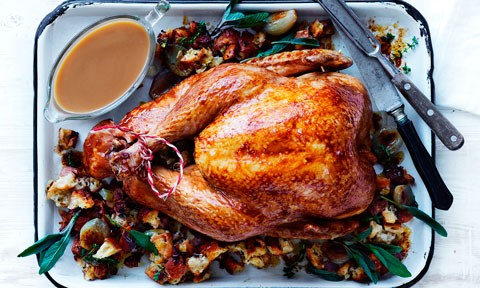 A whole roast turkey in a serving plate