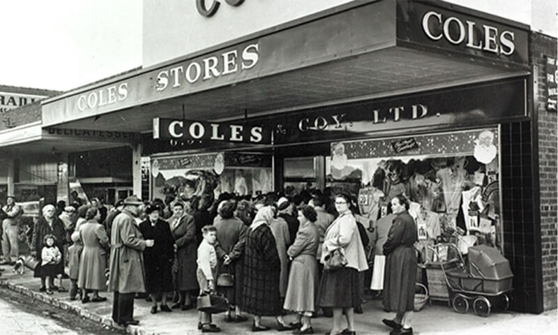 First Coles store to open showing customers gathered outside shop front in Collingwood, Melbourne