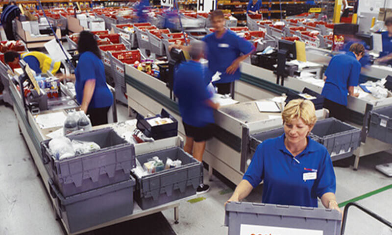 Inside online shopping dispactchment centre with Coles team members working