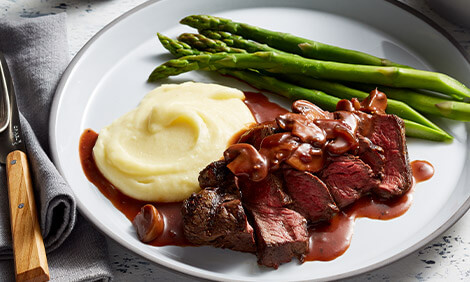 Grilling steak with mash potato and asparagus