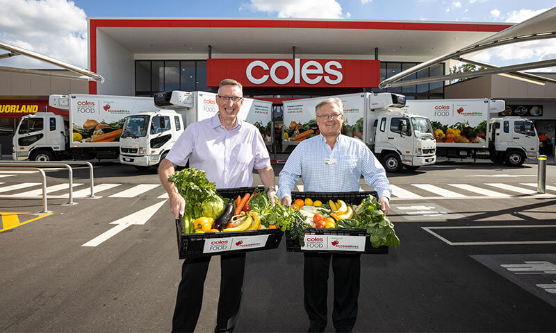 Steven Cain and Second Bite employee standing outside a Coles store with produce in a box 