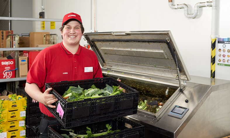 Coles Southland team member Xavier processing food waste