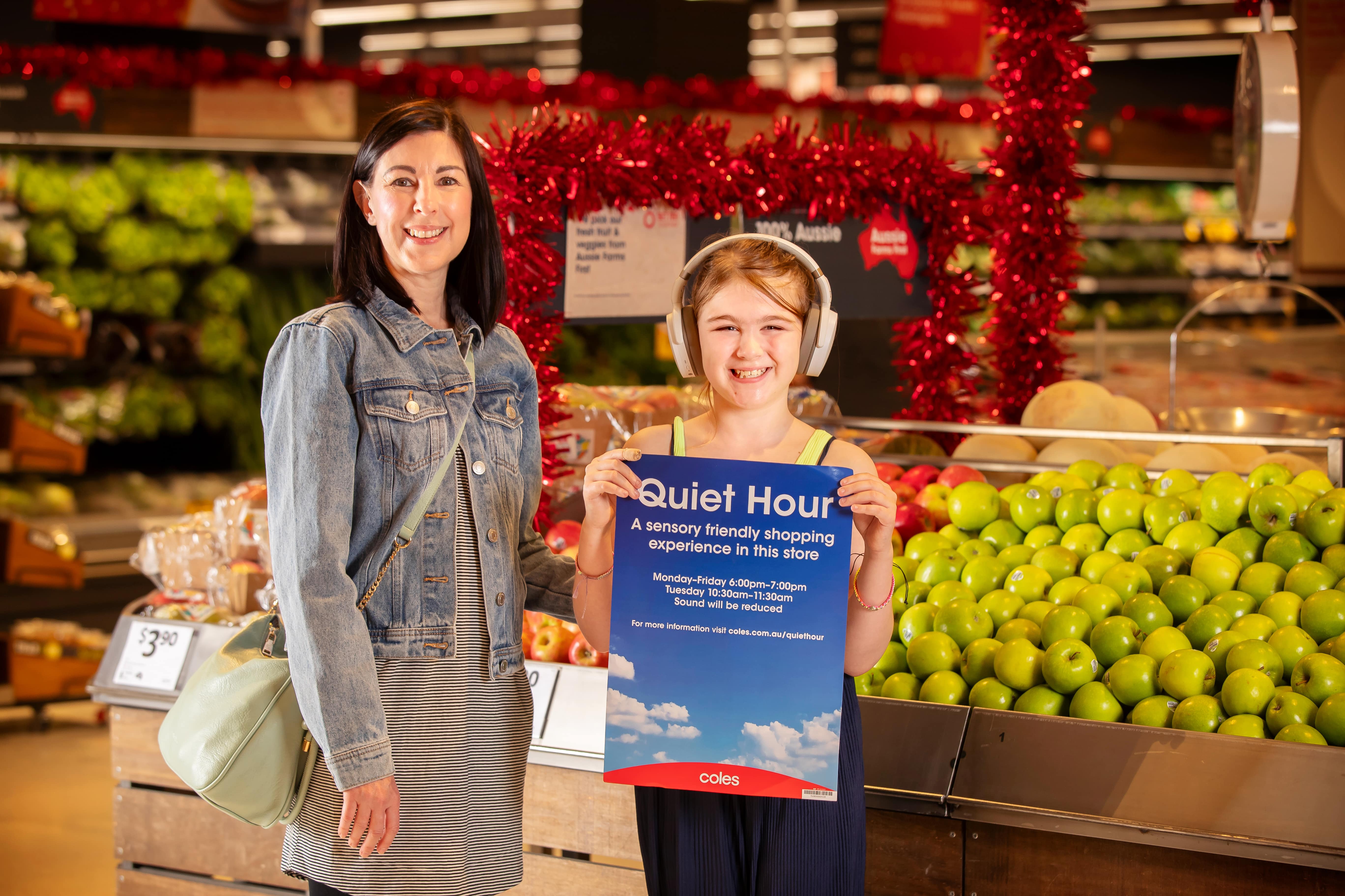 Customer and daughter holding quiet hour sign