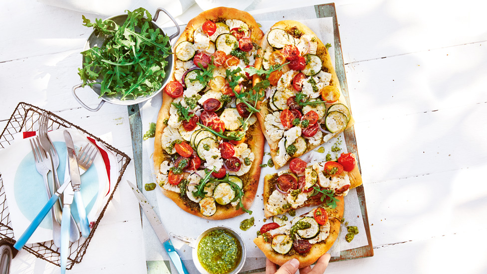 Two BBQ cauliflower pizzas with rocket on the side