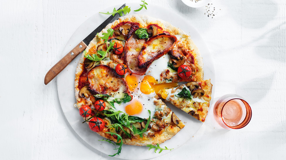 Classic big breakfast pizza with bacon, eggs and mushrooms