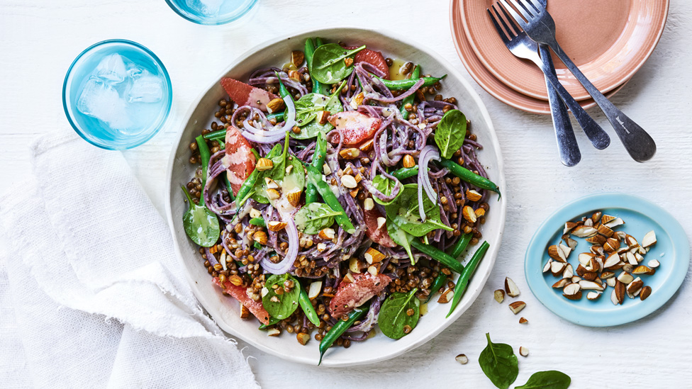 Black noodle salad with lentils and pink grapefruit with crushed almonds on the side