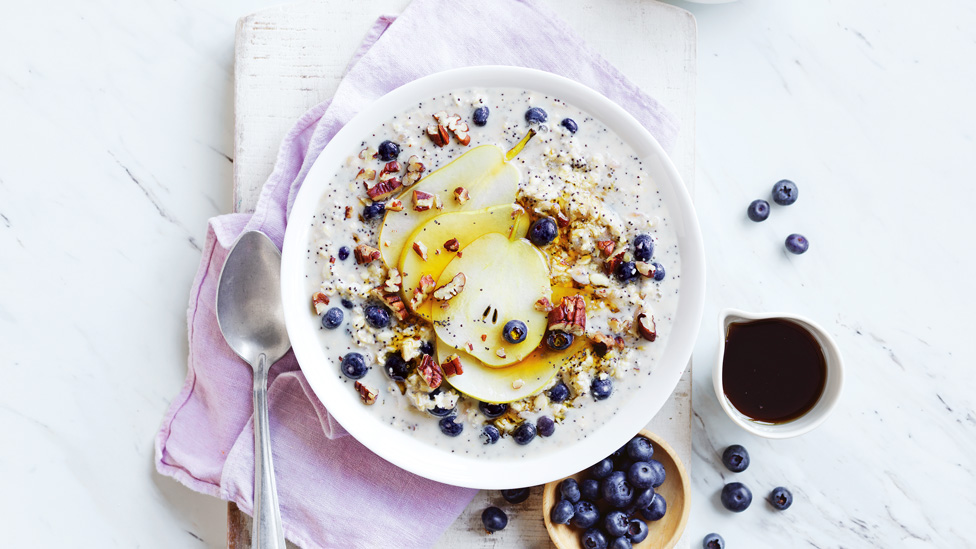 Blueberry and poppy seed overnight oats with additional blueberries and maple syrup