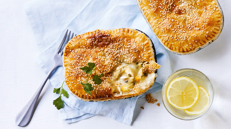 Two chicken, corn and leek pie with lemon slices