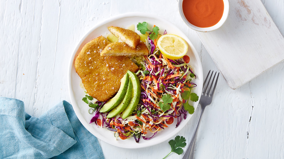 Chicken-free Schnitzel with Slaw on plate with avocado and a lemon wedge