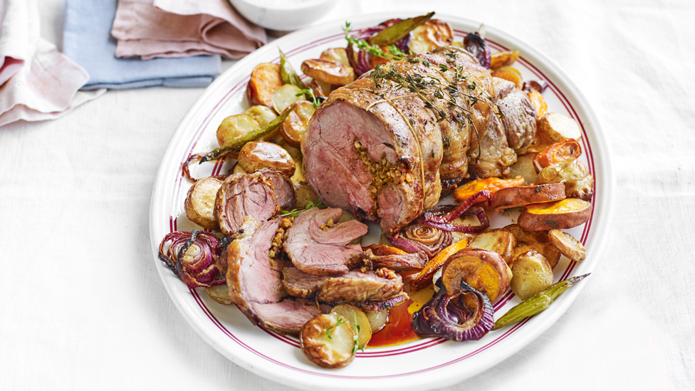 Chilli and Parmesan Roast Lamb sliced on roast vegetables. Topped with sprigs of thyme.