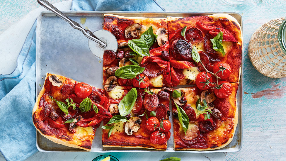 Whole chorizo and mushroom pizza cut into squares