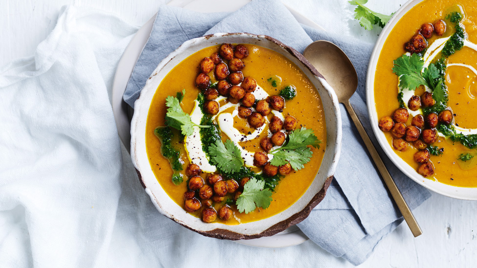 Creamy Spiced Pumpkin Soup with Red Lentils served with yoghurt, chickpeas and parsley.