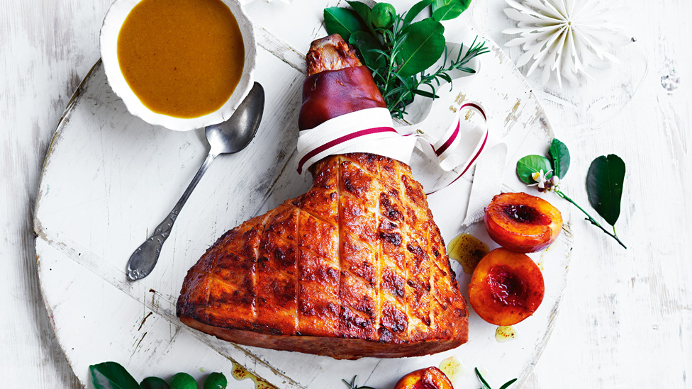 A glazed ham served with peach and gravy