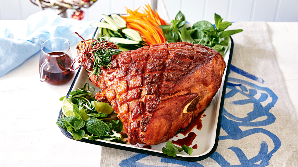 Sweet and spicy glazed ham on a baking tray