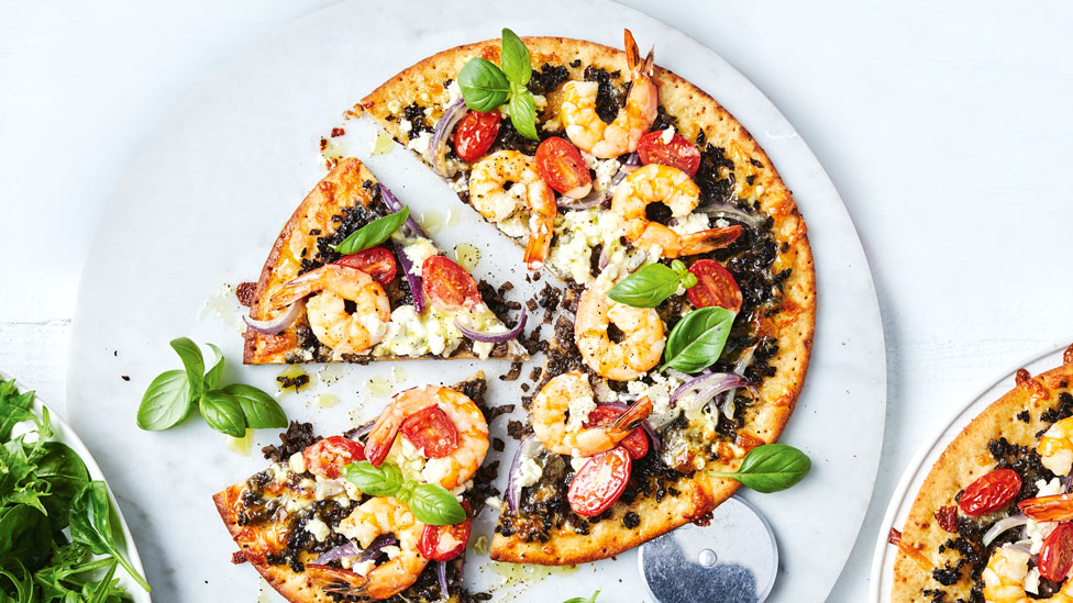 Garlic mushroom mince and prawn pizza cut into wedges